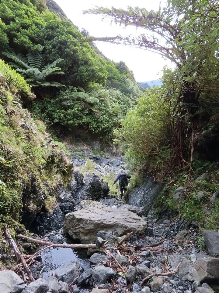 Tramper in a boulder-filled stream bed