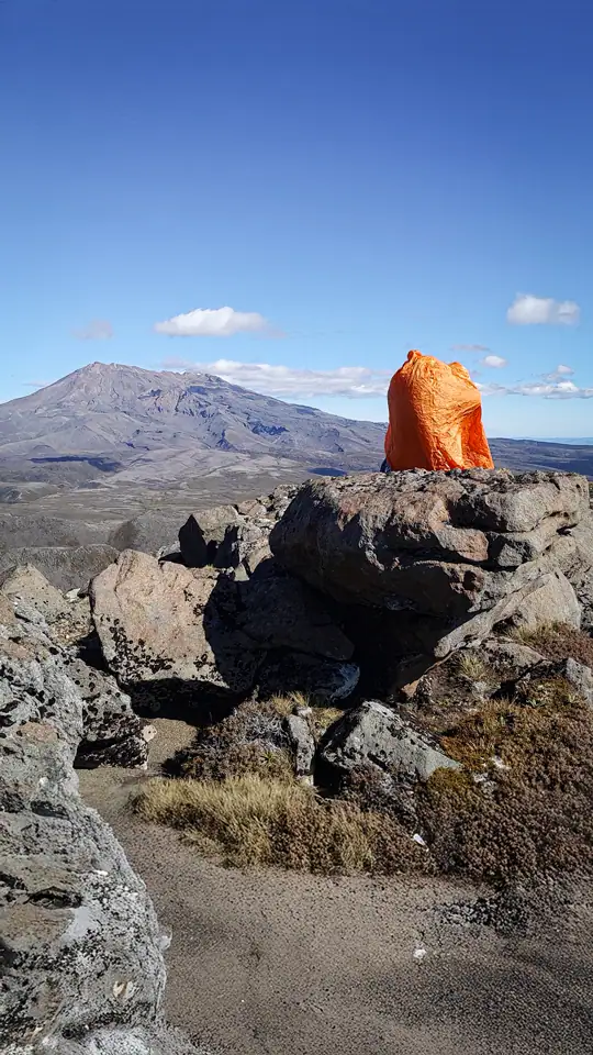Sarah in the shelter of her bothy bag on the summit of Pukekaikiore