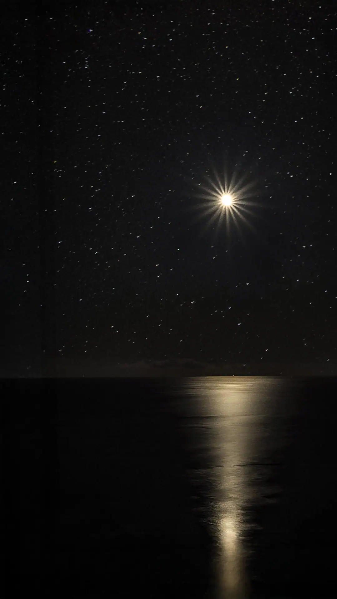   Moon reflected in Cook Strait on the Makara Walkway at night 