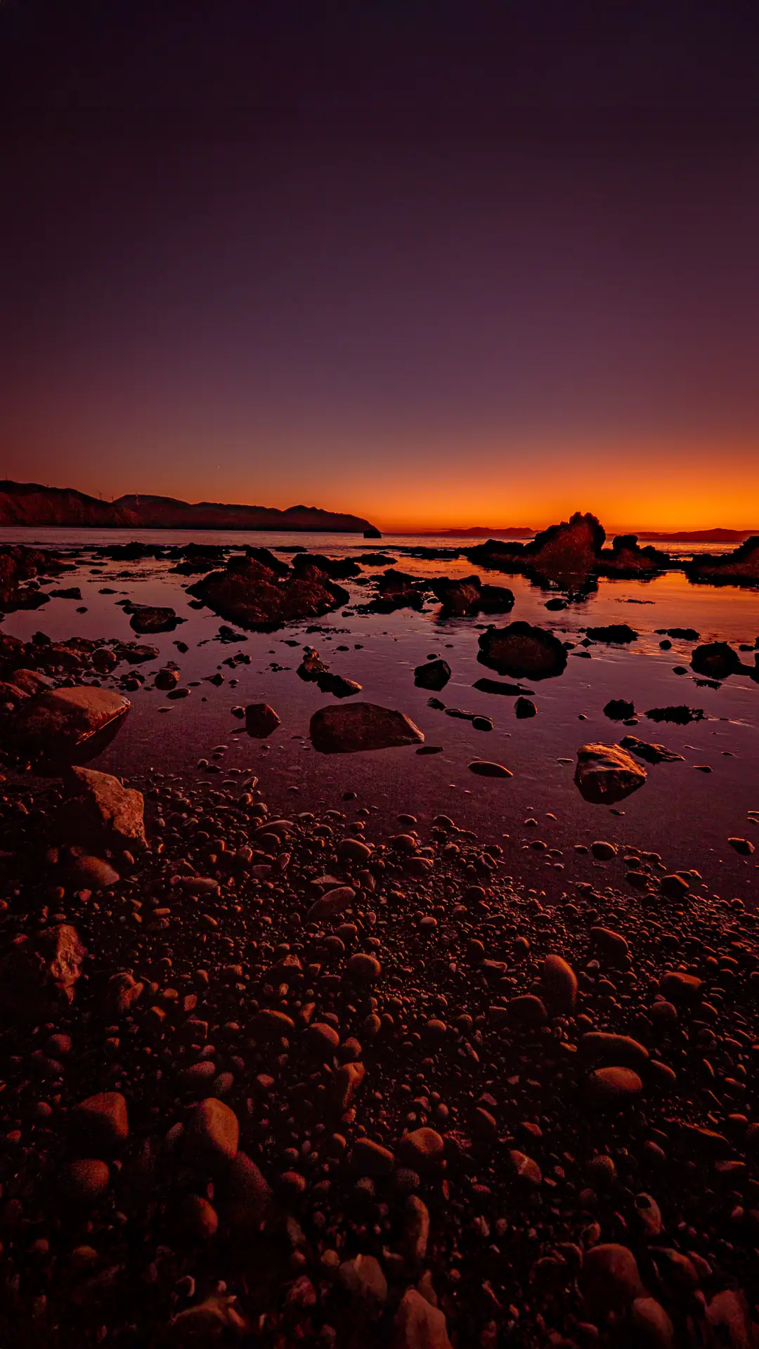  Makara Walkway after sunset with a calm ocean and purple haze 