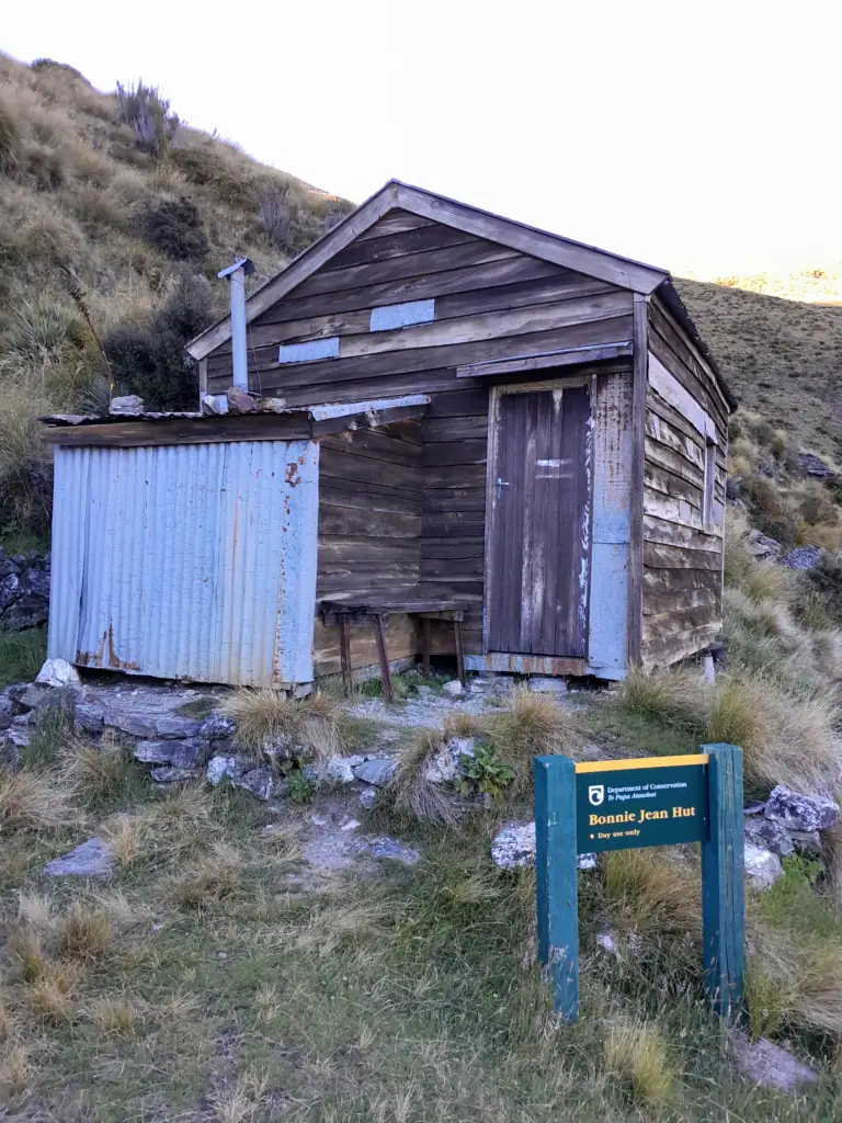 The historic Bonnie Jean Hut, a rustic timber and corrugated iron mining hut located in the Whakaari Conservation Area on the way to the Judah Track, New Zealand