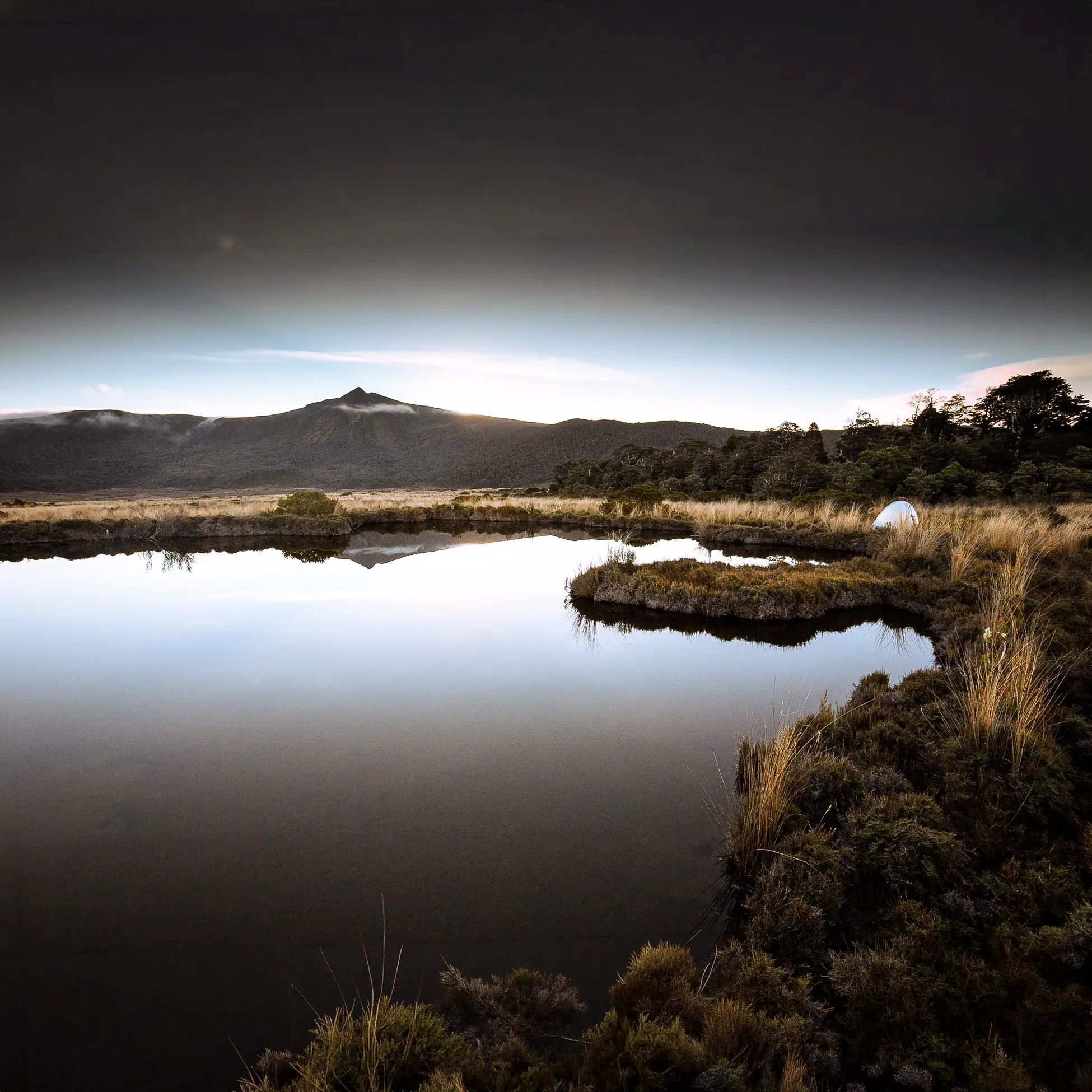 The view across the calm tarn reflects the true tranquility of the wilderness
