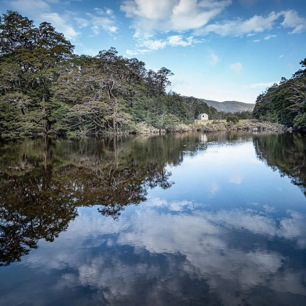 Old Man Hut viewed over an ephemeral tarn on a fine calm day