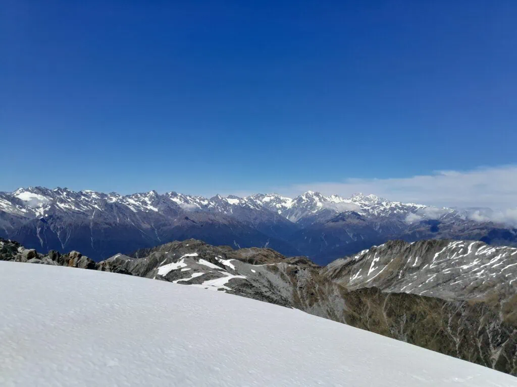 A view of snow capped mountains in the southern alps that a hiker saw during a climb up Mt Adams