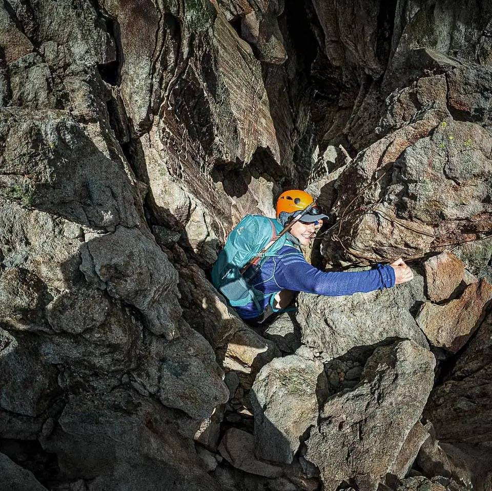 A hiker begins the descent of the chimney north of the Sharks Tooth into the crater and then up to the actual summit