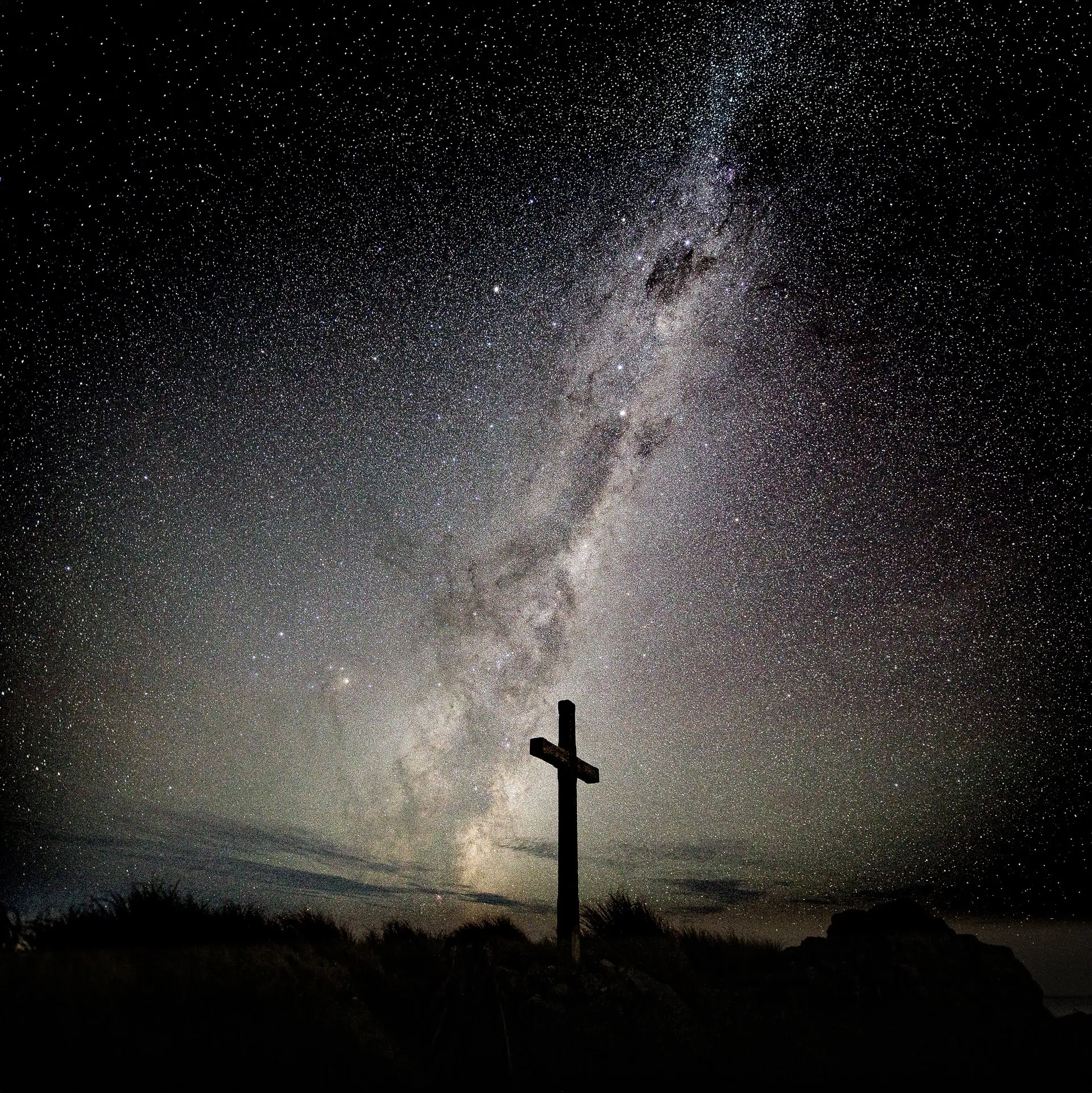 A poignant photo of the Mt Hector Memorial Cross with the Milky Way galactic center behind on a unusually clear and calm night