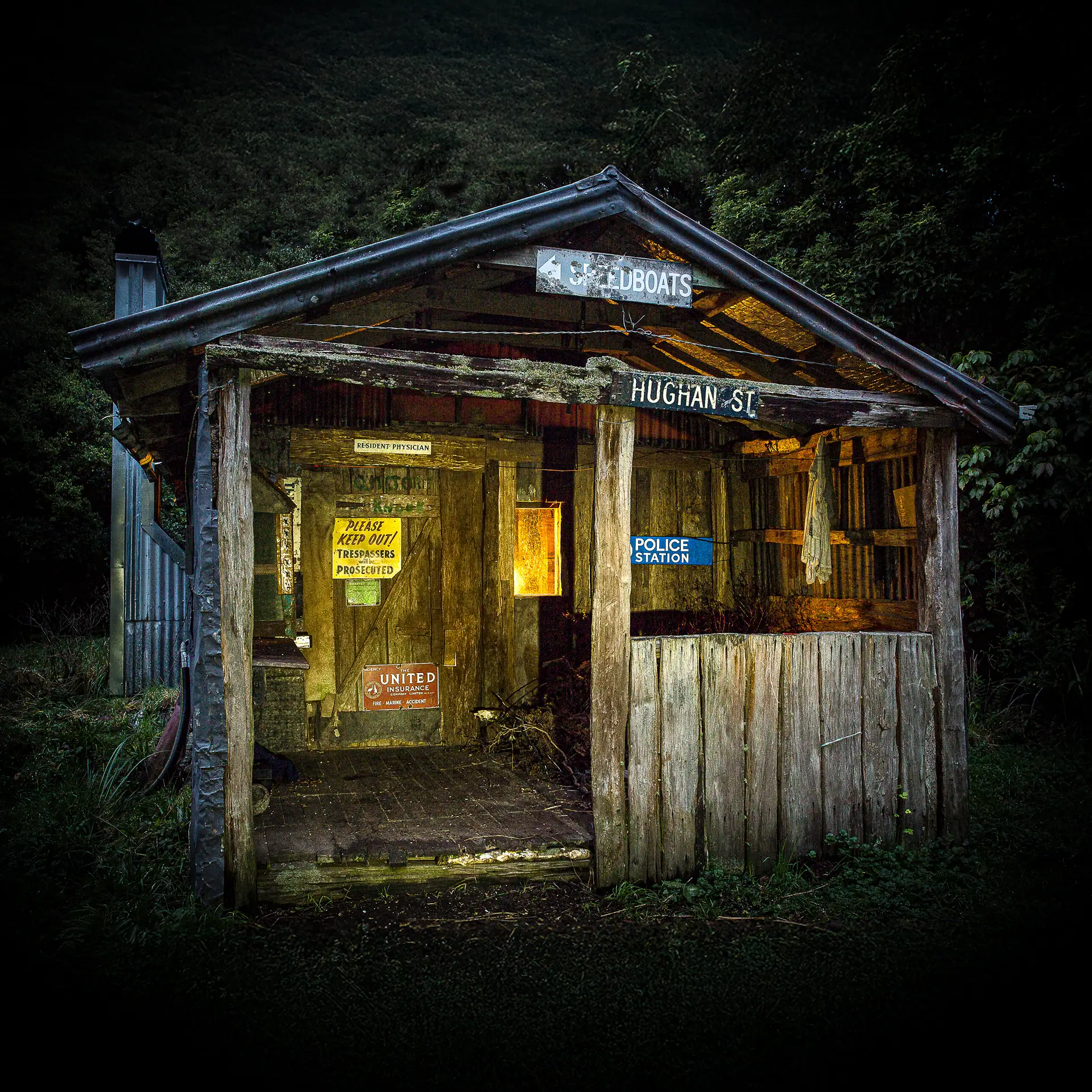 Nighttime photo of Sayer Hut illuminated by candles inside and showing the exterior decorations