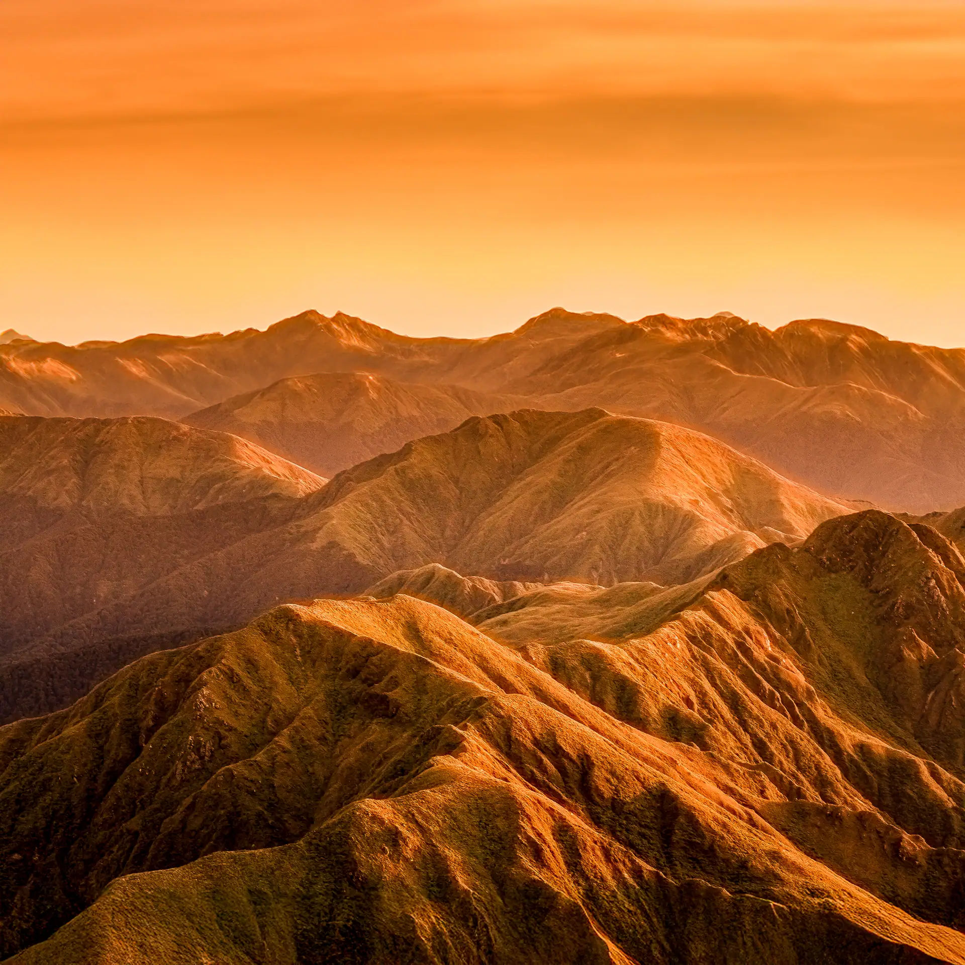 Dramatic photo of the Tararua Southern Main Range with Mitre behind showing the summit accordance of all the highest peaks 
