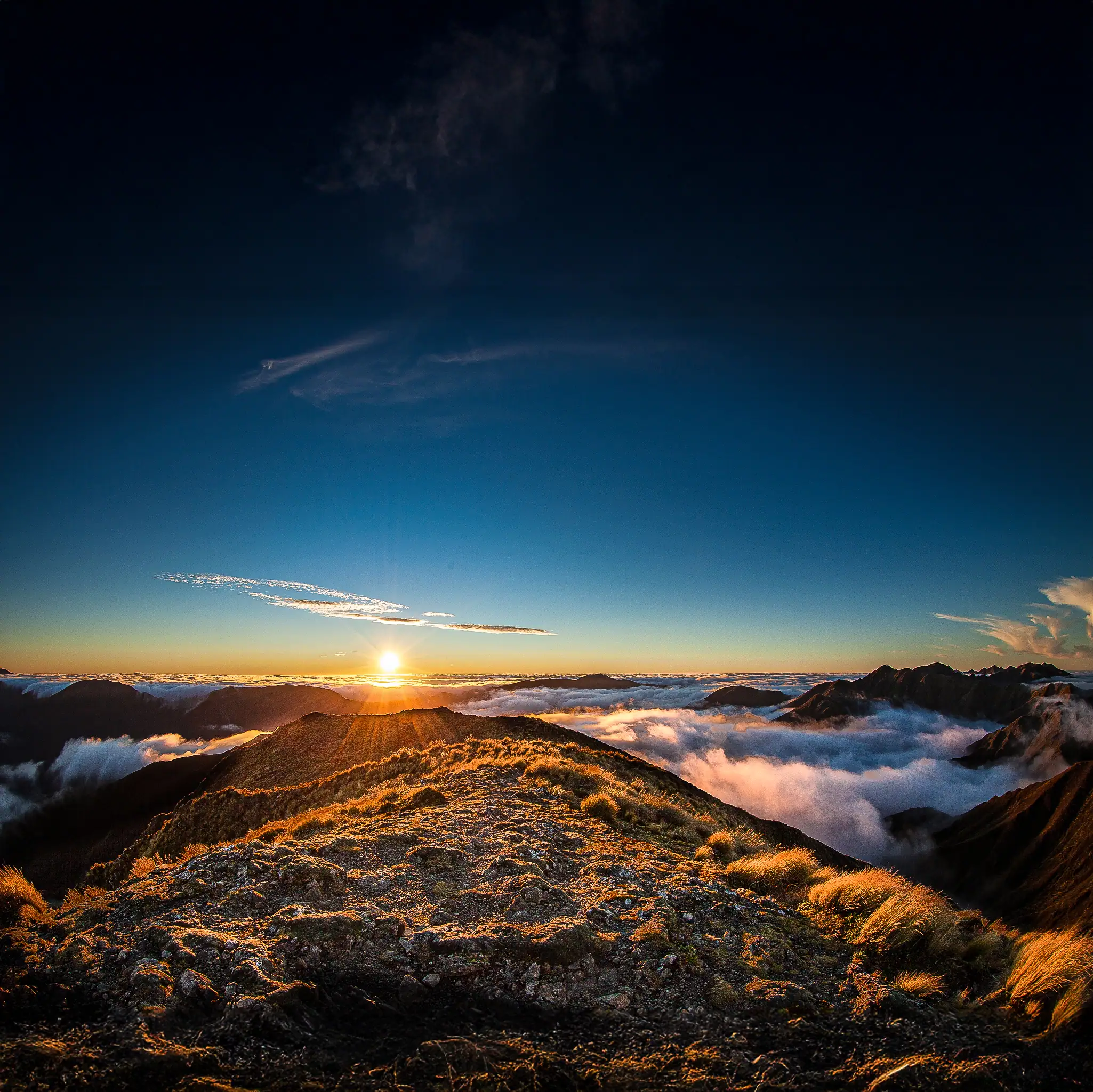 The sun sets in glorious colors viewed from Mt Holdsworth, Tararua Range, on a very rare fine and clam evening