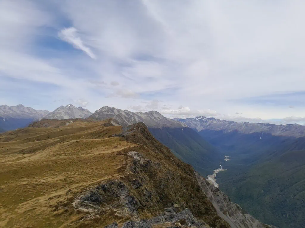 A tussock covered Mahanga Range with Mt Windward and D'Urville Valley