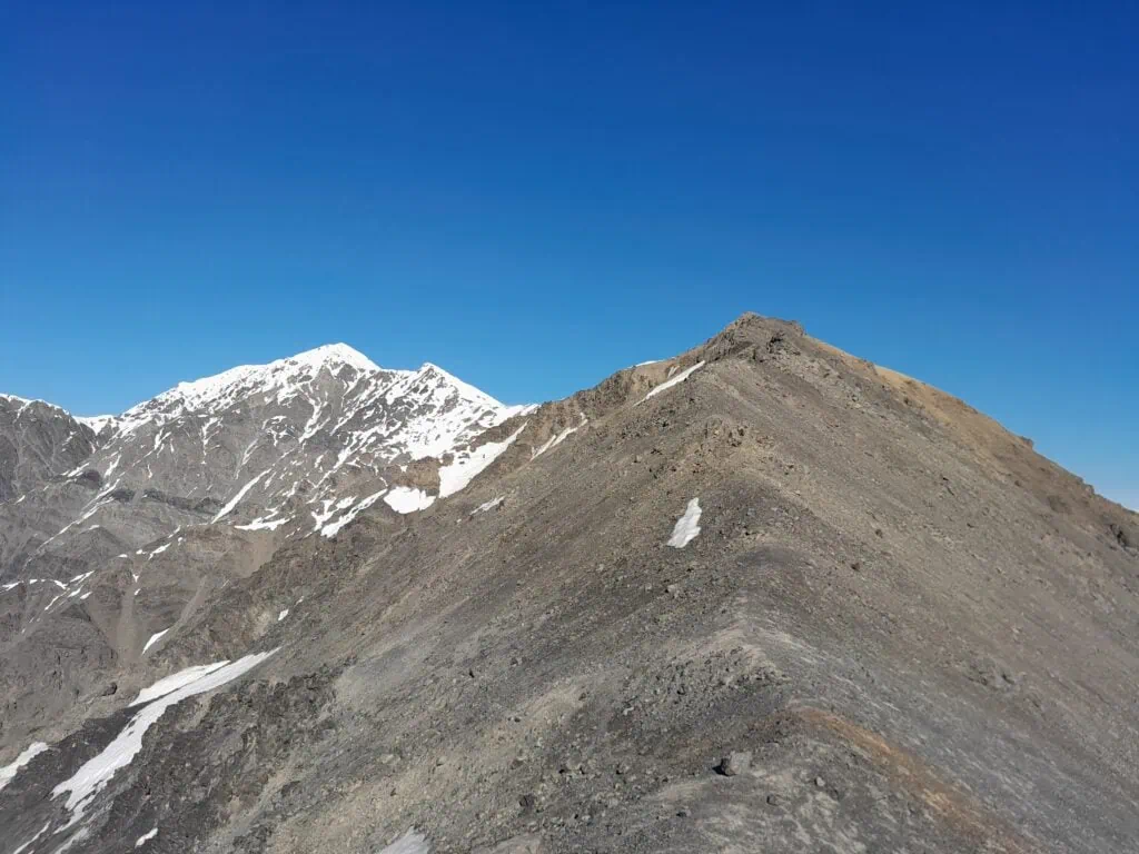 Crumbling greywacke rock with snow higher up George Spur with Mt Tarahaka in the distance