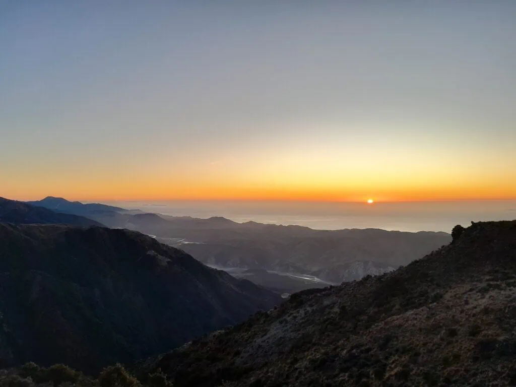 A rising sun over the Clarence River in Seaward Kaikōura Range in Ka Whata Tu o Rakihouia Conservation Park