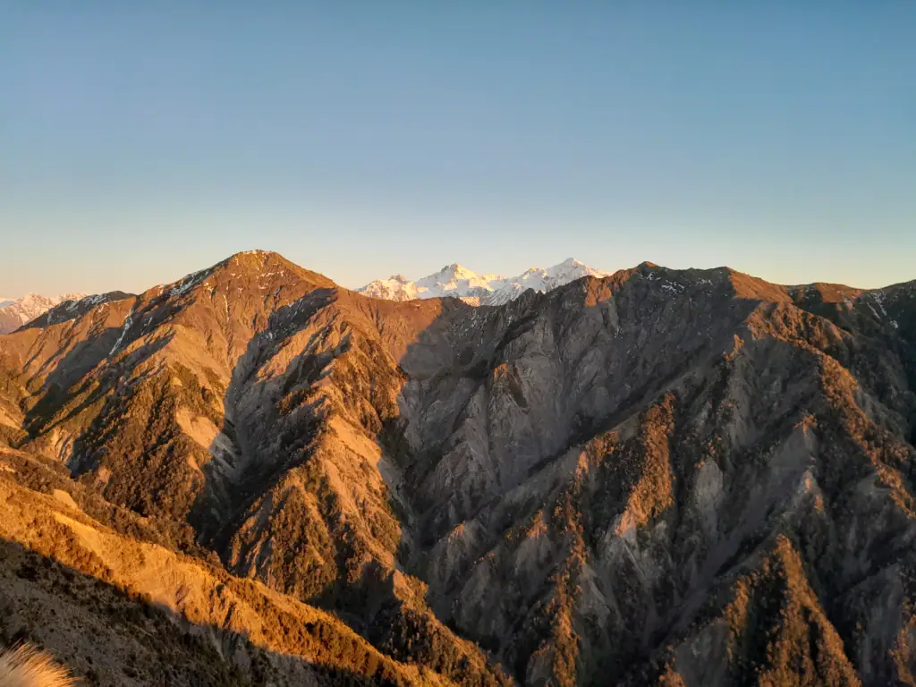 Snowy peaks of Mitre, Alarm and Tapuae-o-Uenuku peaks in the Inland Kaikōura Range as viewed from George Spur on route to Mt Tarahaka