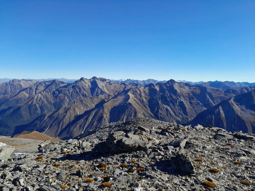 Distant view of Mt Aspiring and the Southern Alps seen from the summit of Mt Gladwish in New Zealand. Panoramic view from the 1861-metre summit of Mt Gladwish looking over the rugged peaks of the Southern Alps.