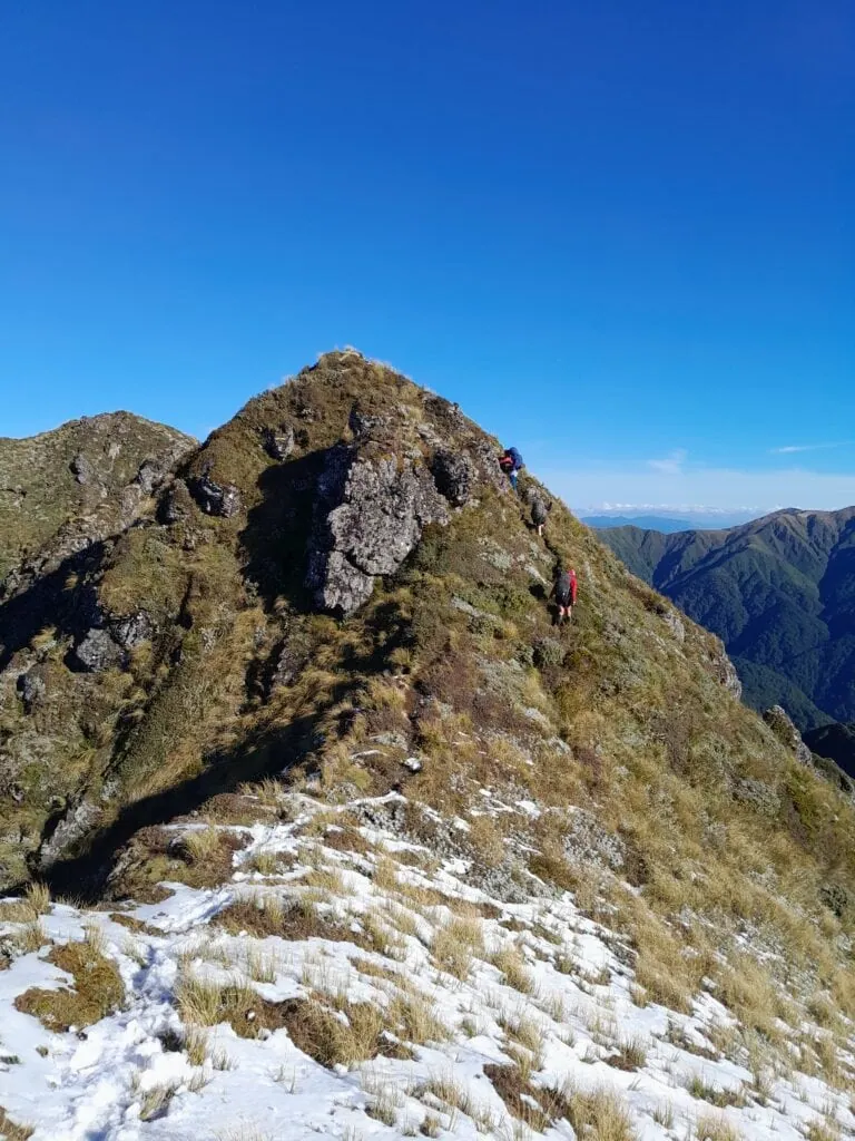 Snow covered tussock and a steep climb before Pourangaki Hut in the Ruahine Range