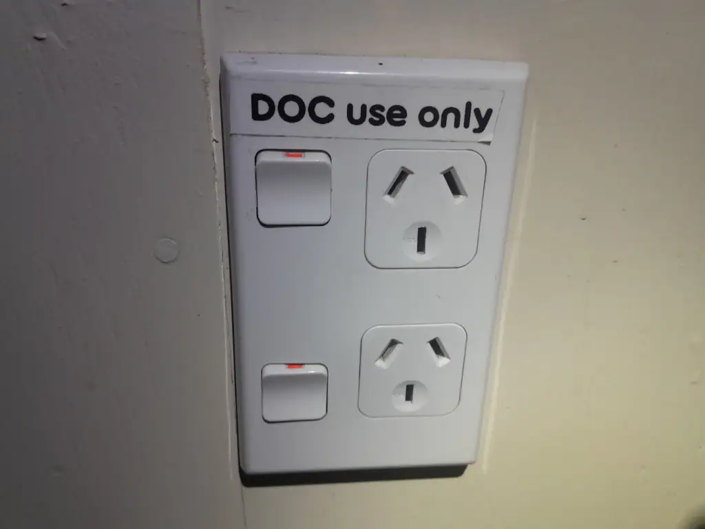 A Department of Conservation power outlet in Kelly Knight Hut as a joke in the Ruahine Range
