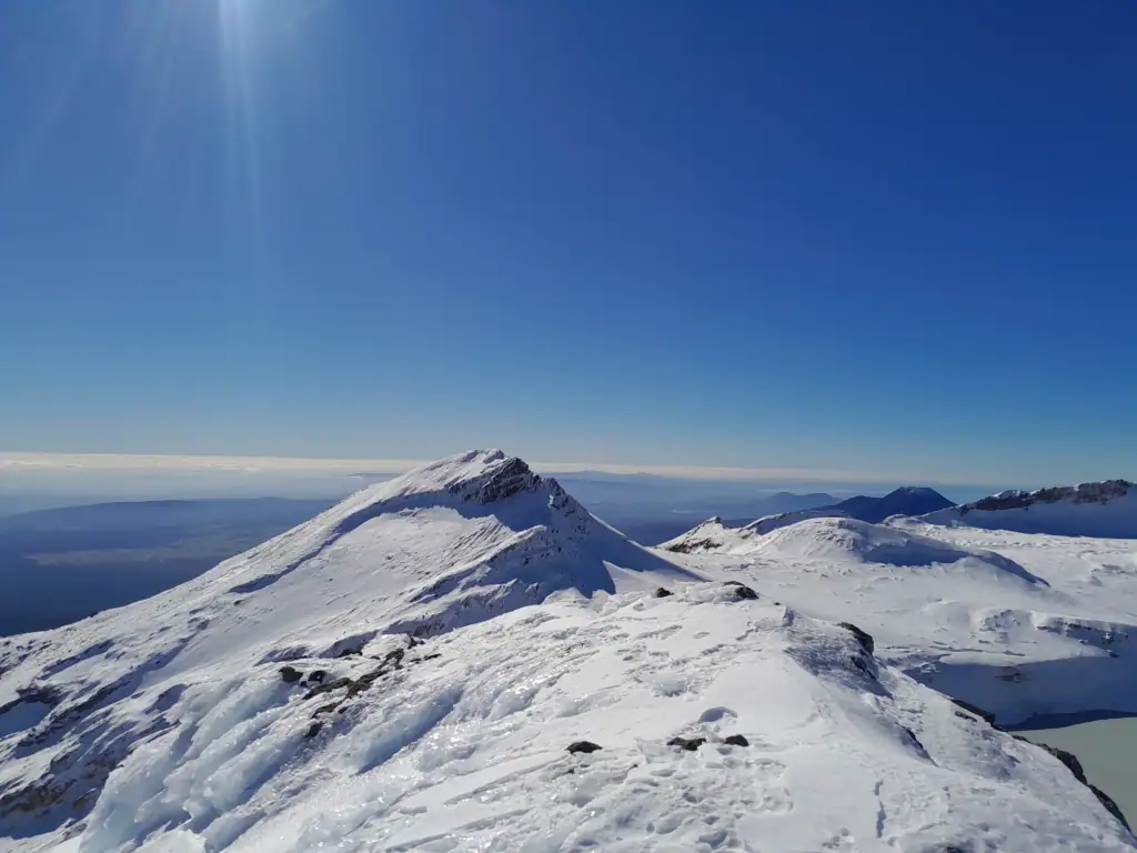A view from Te Ātaahua (Point 2757) across to the second highest snow covered peak Paretetaitonga and to its right, Dome. 