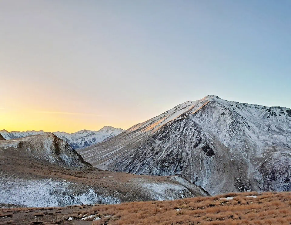 Sunset with an alpen glow on the snowy peaks of the Potts and Big Hill Range in Hakatere Conservation Area, Canterbury high country