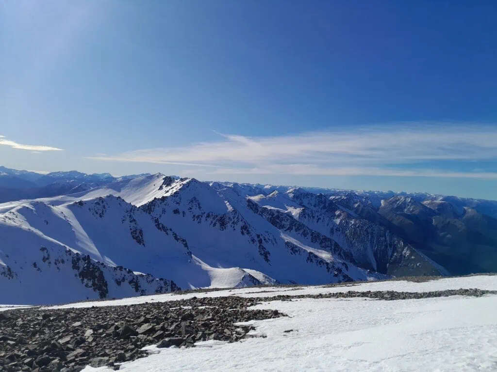 Looking along a rocky, snow-covered ridgeline toward Mt Cheeseman Peak in the Craigieburn Range, Canterbury.