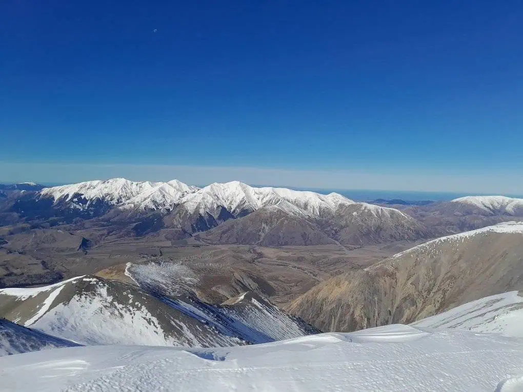 Panoramic view of the snow-capped Torlesse Range and Castle Hill basin taken from the upper slopes of Mount Cloudsley, Craigieburn Forest park, Canterbury