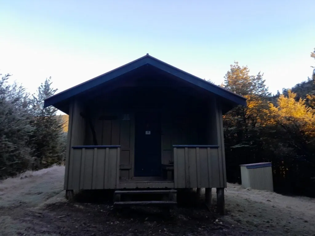 Exterior view of Wharfedale Hut on a frosty morning in Mt Oxford Forest Park, Canterbury