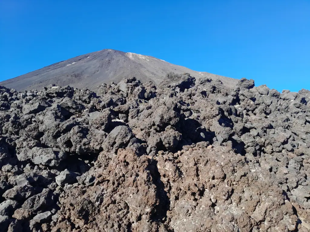 Close-up of rugged, sharp volcanic lava rocks and dark scoria fields on the slopes beneath Mt Ngauruhoe in Tongariro National Park