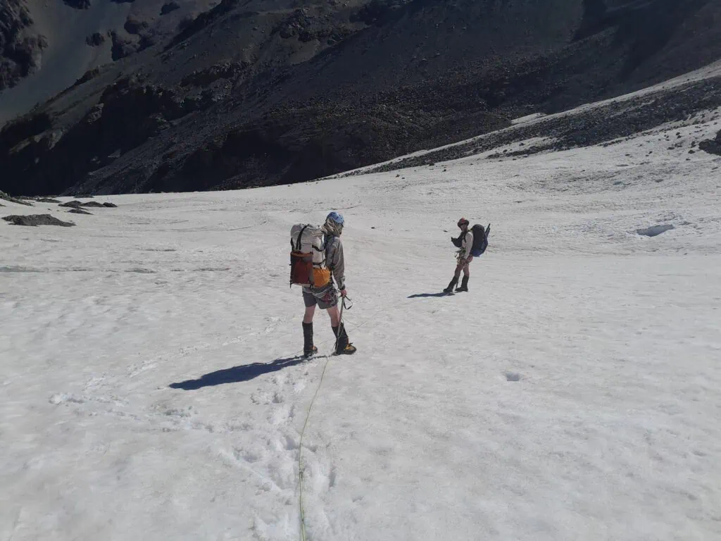 Two hikers on a harness and rope on the Ashburton Glacier in the Arrowsmith Range, Hakatere Conservation Park, Canterbury