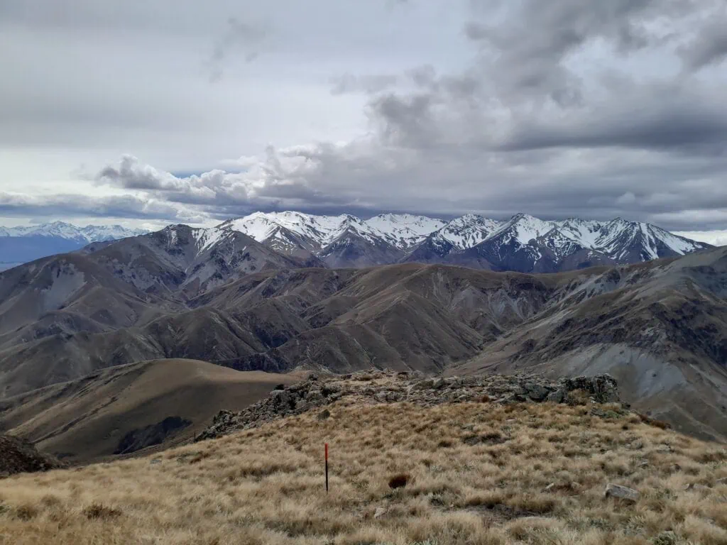 Descending the steep, unformed Te Kiekie Route from the Mt Somers summit, looking out at the Winterslow Range, Old Man Range & Mount Somers Range in Hakatere Conservation Park, Canterbury