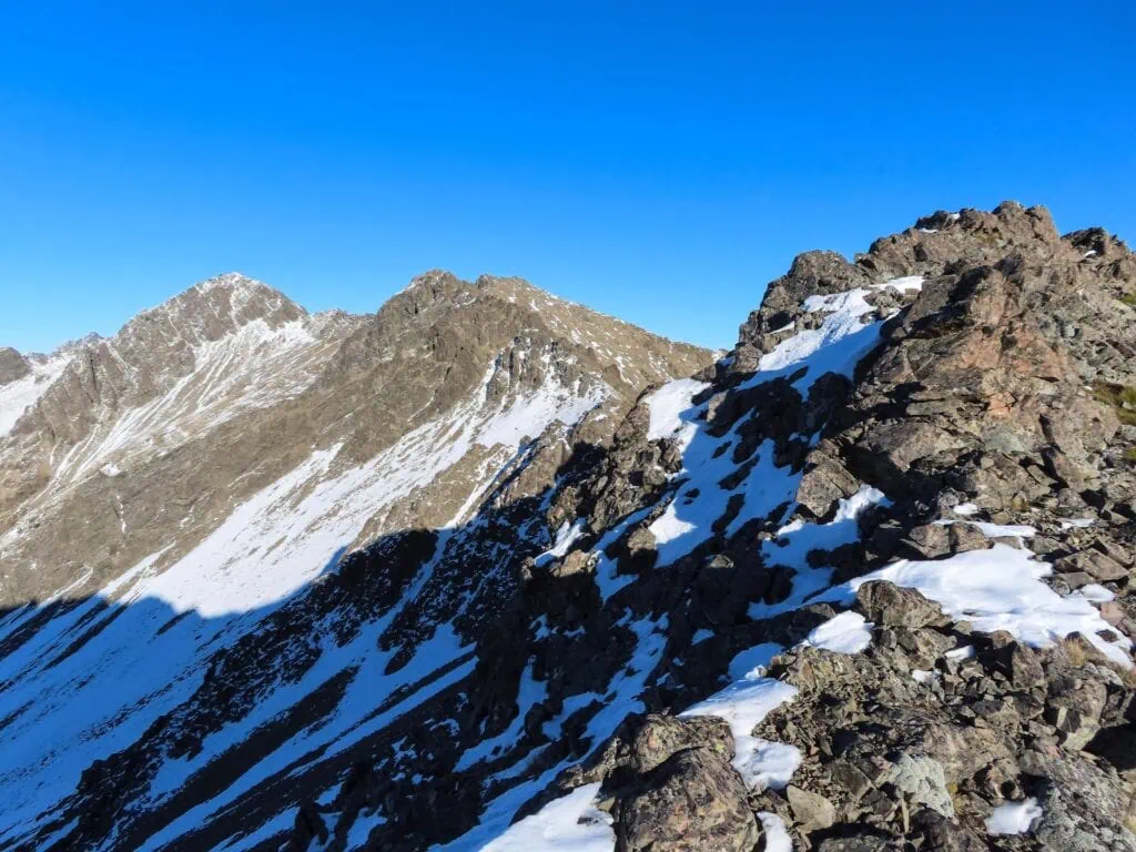 Snow-dusted rocky alpine ridgeline and mountain peaks along Bounds Ridge, Leatham Conservation Area