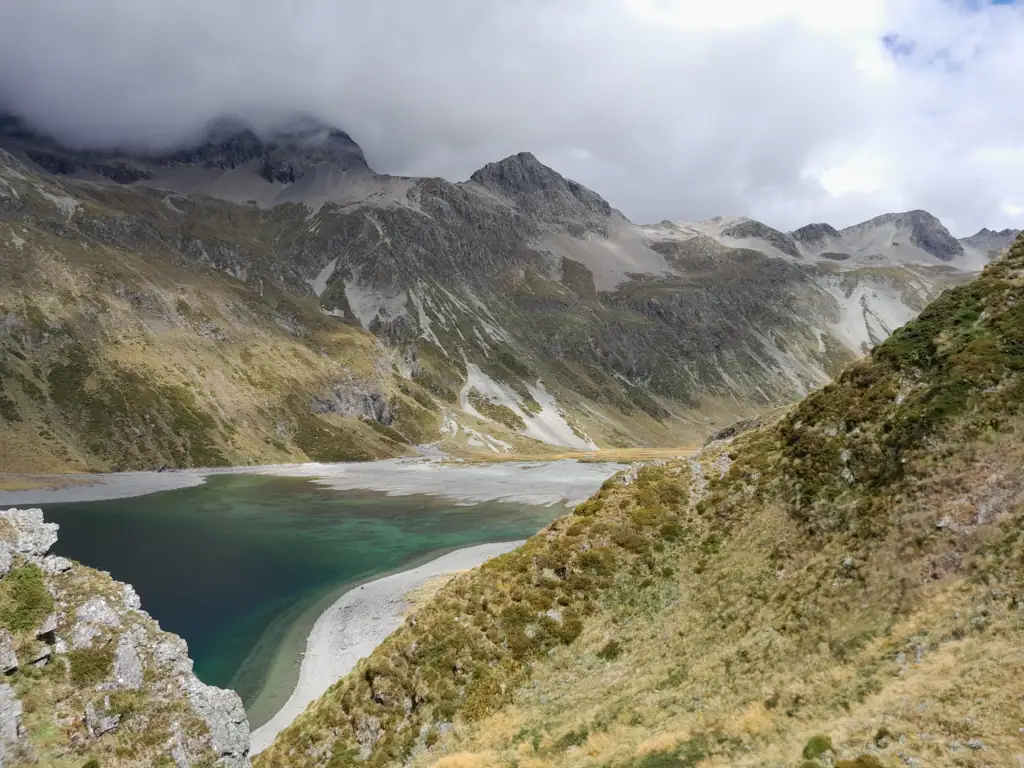 View looking down at the clear, shallow turquoise waters of Lake Constance/Rotopohueroa from the west on the high sidling track on the Waiau Pass Route, Nelson lakes National Park