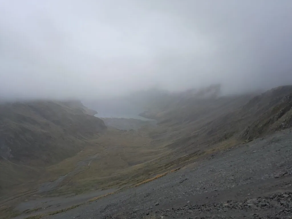 Misty alpine landscape with heavy clag obscuring the view of Lake Constance on the Waiau Pass Route, Nelson Lakes National Park