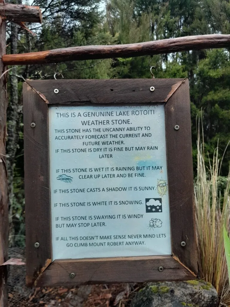 Lake Rotoiti Weather Stone sign in St Arnaud detailing funny rules for forecasting weather in Nelson Lakes National Park.
