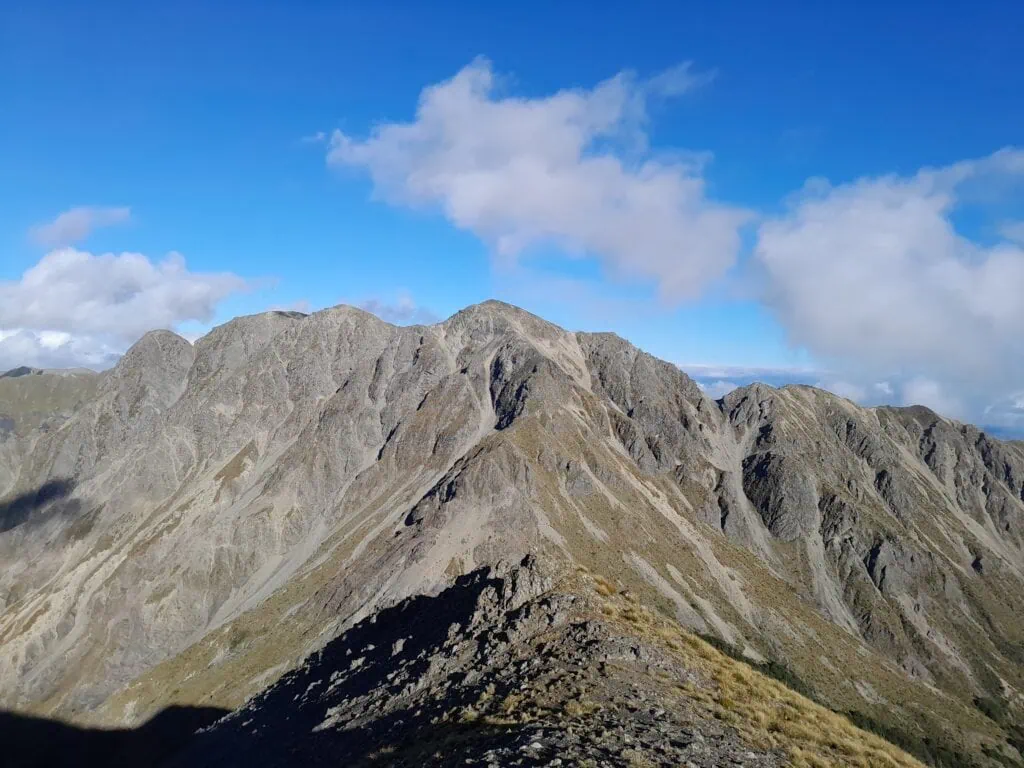 Panoramic view of the rugged, rocky peak of Mt Horrible viewed from Mt Harkness in Ferny Gair Conservation Area, Marlborough.