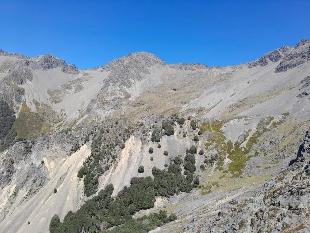 Rocky scree slopes and steep mountain faces leading up toward Bounds Peak in the Raglan Range, Marlborough.